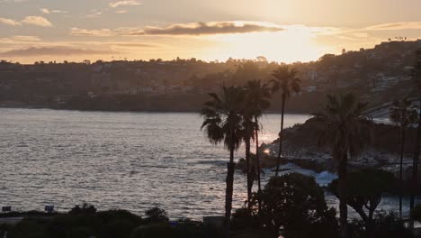 La-Jolla-Cove-Drone-Sunrise-Horizontal-Right-to-Left-Move-with-Parallax-Effect-on-nearby-Palm-Trees