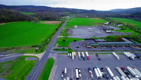 Drone-view-of-a-truck-stop-in-PA,-featuring-a-variety-of-parked-semi-trucks-supporting-freight-operations