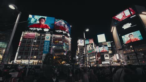 Shibuya-Scramble-Crossing-With-Crowd-Of-People-At-Night---Panning-Shot