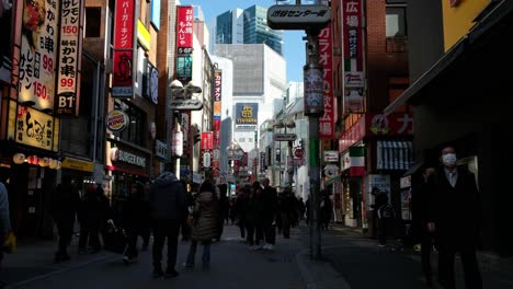 Japanese-tourists-shopping,-road-crossing,-using-transportation-in-Akihabara,-Tokyo,-browsing-the-latest-games-and-exclusive-merchandise-amid-the-vibrant-atmosphere,-store-opening-in-Japan-4K-30fps