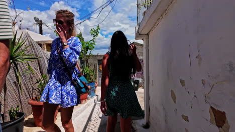 Slow-motion-follow-shot-of-people-walking-narrow-streets-of-Anafiotika