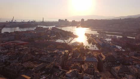 Genoa's-historic-center-at-sunset,-highlighting-the-bustling-port-and-vibrant-cityscape,-aerial-view