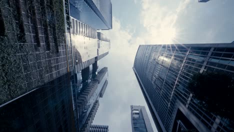 Abstract-time-lapse-looking-up-driving-through-the-business-district-in-Singapore