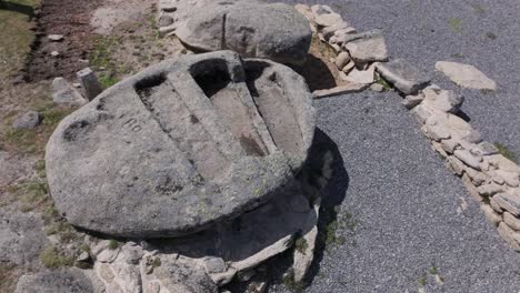 orbital-and-ascending-flight-with-drone-where-we-see-3-anthropomorphic-tombs-from-the-Visigoth-era-excavated-in-a-rock-there-is-dark-gravel-from-the-archaeological-zone-there-are-remains-of-walls