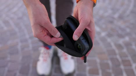 A-person-unzips-a-protective-case-and-reveals-an-Insta360-x4-action-camera