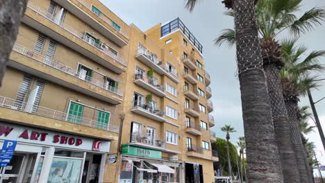 Residential-building-and-palm-trees-along-a-street-in-Nicosia,-Cyprus