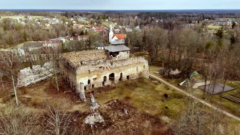 Rauna-Castle-Ruins-With-Lutheran-Church-In-Background-During-Fall-Season