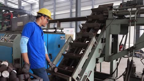 close-up-seen-men-pouring-the-raw-material-of-the-forging-plant-into-the-machine,-Industrial-safety-first-concept