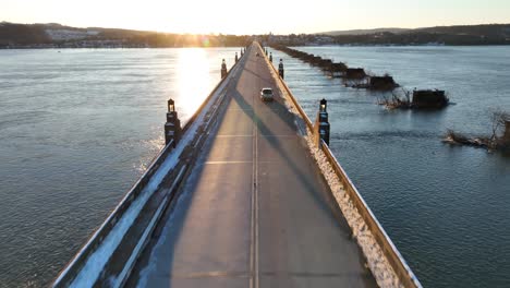 Snow-covered-bridge-during-winter-sunset