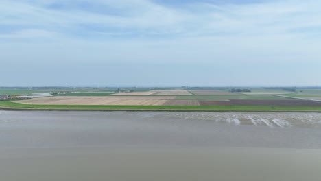 Aerial-footage-over-the-coast-in-Zeeland,-Netherlands-during-low-tide