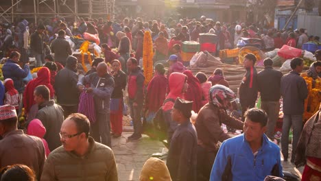 Medium-shot-of-people-walking-through-market-square,-Bhaktapur,-Kathmandu-Valley,-Nepal