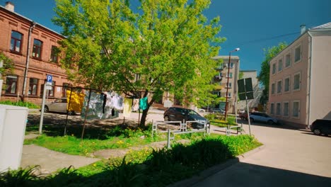 Laundry-drying-on-courtyard-understanding-tree-in-sunlight-in-centraal-European-city