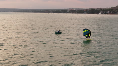 Aerial-Tracking-Shot-Of-A-Wing-Foiler-Hydrofoil-Carving-In-Slow-Motion