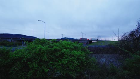 Beautiful-aerial-of-Dry-vans,-reefers-driving-on-interstate-80-in-Pennsylvania-in-the-evening