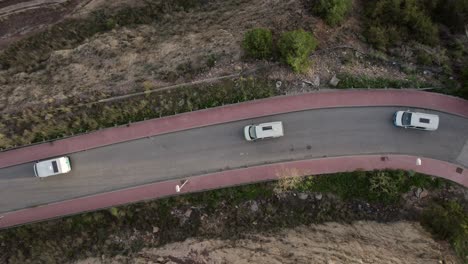 Aerial-view-of-a-line-of-campers-driving-in-Malaga-with-the-first-rays-of-the-sun