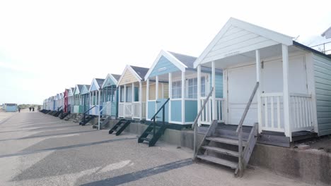 Row-of-colourful-wooden-family-holiday-beach-huts-seaside-front