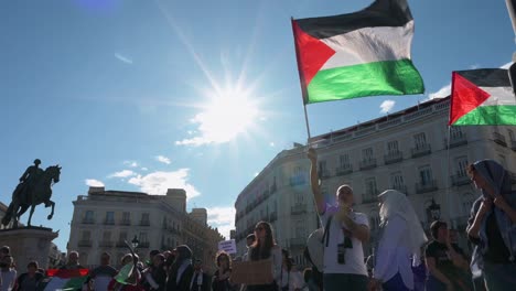 Protesters-hold-Palestinian-flags-during-a-pro-Palestine-demonstration-demanding-that-the-Spanish-government-stop-the-sale-of-arms-to-the-State-of-Israel-in-Madrid,-Spain