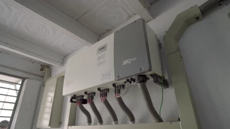 Looking-Up-At-Solar-Inverter-Box-Fixed-To-Wall