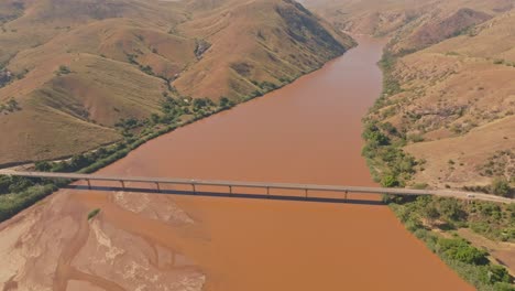 Top-down-view-of-car-crossing-huge-bridge-above-Tsiribihina-River-in-Madagascar-countryside