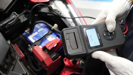 Technician-Check-Car-Battery-Voltage-Using-Equipment,-Close-Up