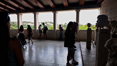 Hills-of-Athens-view-from-Museum-of-Ancient-Agora,-young-woman-visiting-Stoa-of-Attalos