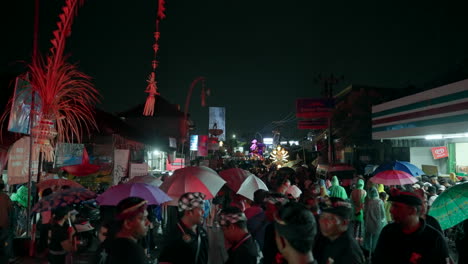 Busy-festival-parade,-city-decoration,-evening-darkness,-people-costumes