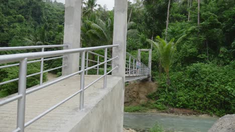 Mujer-Turista-Cruzando-El-Puente-Sobre-El-Río-De-La-Selva-Tropical-En-Filipinas