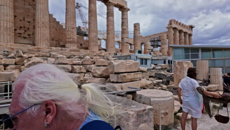 Ancient-greek-architecture-with-ionic-columns-aside,-traditional-costumes-worn-by-young-couple