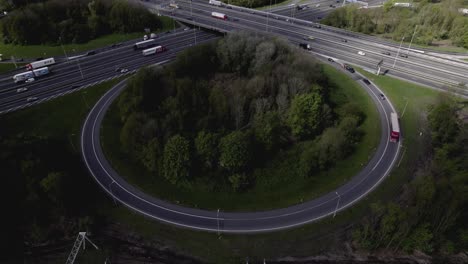 Thick-cloud-shadow-clearing-over-greenery-island-aerial-view-of-transit-roundabout-Hoevelaken-intersection-circle-in-Dutch-landscape