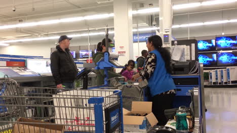 People-paying-tax-software-at-check-out-counter-inside-Walmart-store-with-4k-resolution