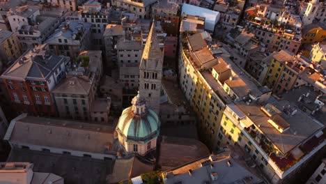 Genoa's-historic-center-at-sunset-with-warm-light-on-colorful-buildings,-aerial-view
