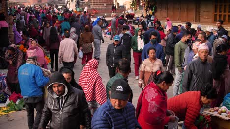 Wide-shot-of-people-walking-through-crowded-market-square-in-Bhaktapur,-Kathmandu-Valley,-Nepal