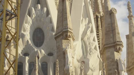 Scenic-architectural-view-of-the-unfinished-La-Sagrada-Familia-detail-shot-with-yellow-crane