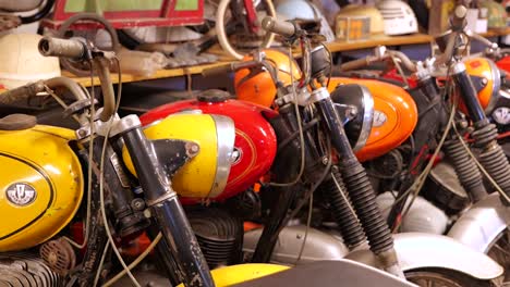 Row-of-colorful,-vintage-motorbikes-in-museum,-close-up