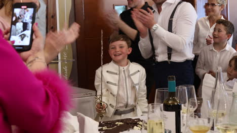 A-Boy-Carries-a-Sword-as-Part-of-a-Traditional-Ceremony-During-His-First-Communion-in-Zaragoza,-Spain---Medium-Shot