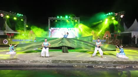 Traditional-dance-of-the-Mandar-tribe-performed-at-Manakarra-beach,-Mamuju,-West-Sulawesi,-Indonesia