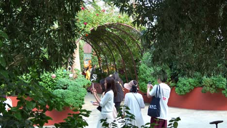 Tourists-walking-into-the-Mediterranean-Garden,-strolling-around-the-world-largest-glass-greenhouse-Flower-Dome-conservatory-at-Gardens-by-the-bay,-static-shot