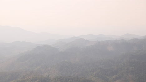 hazy-view-of-mountains-in-the-afternoon-in-the-mountain-town-of-Nong-Khiaw-in-Laos,-Southeast-Asia