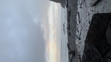 Video-shot-of-the-sunset-on-the-oregon-coast-on-a-foggy-day-and-a-small-waterfall