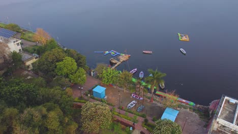 Aerial-drone-shot-of-tourist-boats-and-park-at-upper-lake-of-Bhopal-capital-city-of-Madhya-Pradesh-during-morning-time-in-india