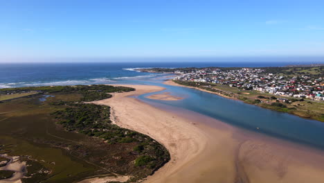 Sweeping-drone-pan-view-over-Goukou-river-estuary-mouth,-Still-Bay-South-Africa