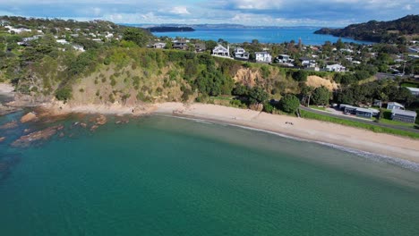 Turquoise-Ocean-And-Sandy-Shore-Of-Big-Oneroa-Beach-In-Auckland,-New-Zealand---Aerial-Drone-Shot