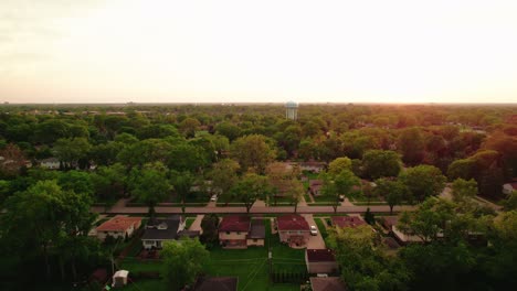 Aerial-view-of-Arlington-Heights,-Illinois-at-sunset-showcasing-residential-houses-and-greenery