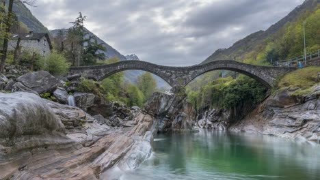 Ponte-dei-Salit-bridge-in-Lavertezzo-Verzasca-Switzerland-with-swirling-green-water