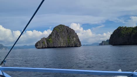 Scenic-Limestone-Rock-in-the-Sea-and-UnInhabited-Islands-in-El-Nido,-Palawan,-Philippines,-Boat-Passenger-POV