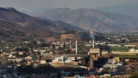 Aerial-perspective-looking-at-the-sugar-cane-factory-in-Tamazula-de-Gordiano,-dolly-out