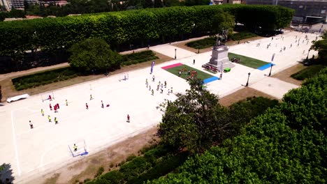 Aerial-revealing-shot-of-children-playing-a-range-of-sports-in-Montpellier