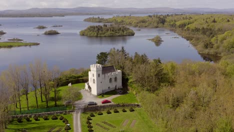 Panoramic-high-angle-aerial-establishes-Cargin-Castle-on-shore-of-Lough-Corrib