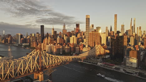 NYC-New-York-Aerial-v371-flyover-Roosevelt-Island-capturing-Queensboro-Bridge-and-morning-sunlight-reflecting-on-waterfront-cityscape-of-Midtown-Manhattan---Shot-with-Mavic-3-Pro-Cine---September-2023