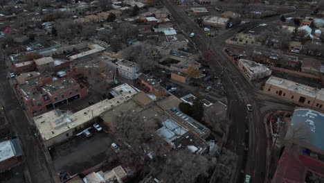 Revealing-Drone-Shot-of-Santa-Fe,-New-Mexico-USA,-City-Buildings-and-Traffic-in-Suburbs-on-Cloudy-Day